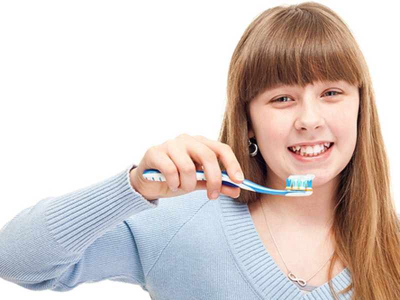 Girl brushing her teeth regularly for healthier mouth & body in Florence, KY & the Tri-State area.